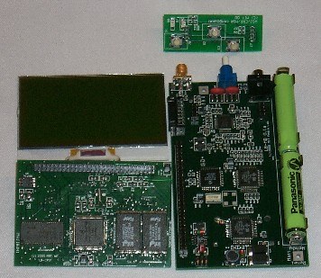 The four Pengachu modules laid out: LCD, processor core, radio mothercard with antenna and AAA cell, and the user-interface board